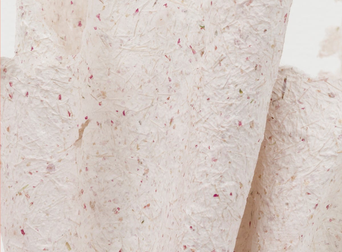 Close-up detail image of Desert Paper 02 basket. Small flecks of brown and red in the textured, white material of the basket.