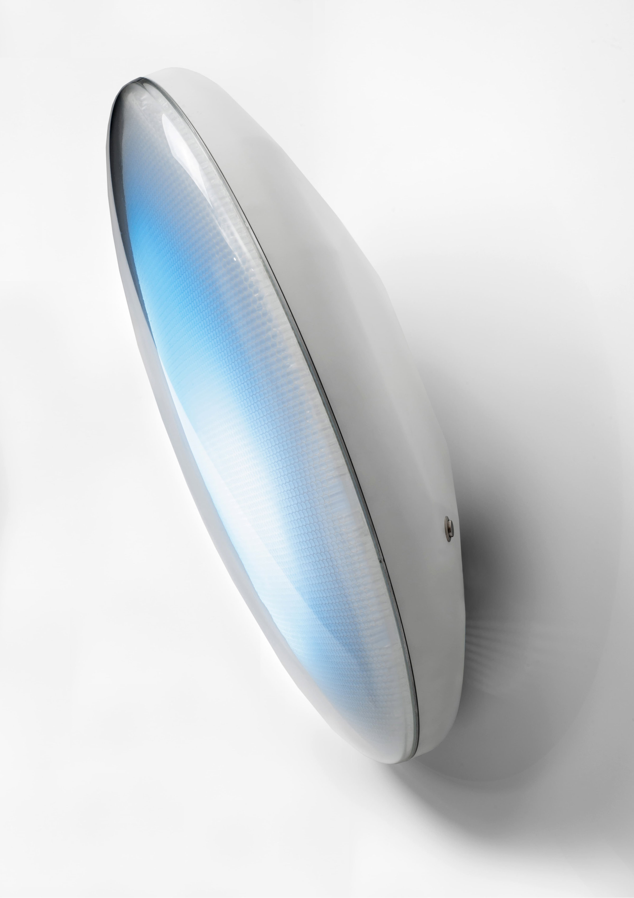 Side view of Tomorrow is Another Day. The artwork is a circular disc with a crescent shaped back. The blue and white screen faces left, with a silver back on the right.