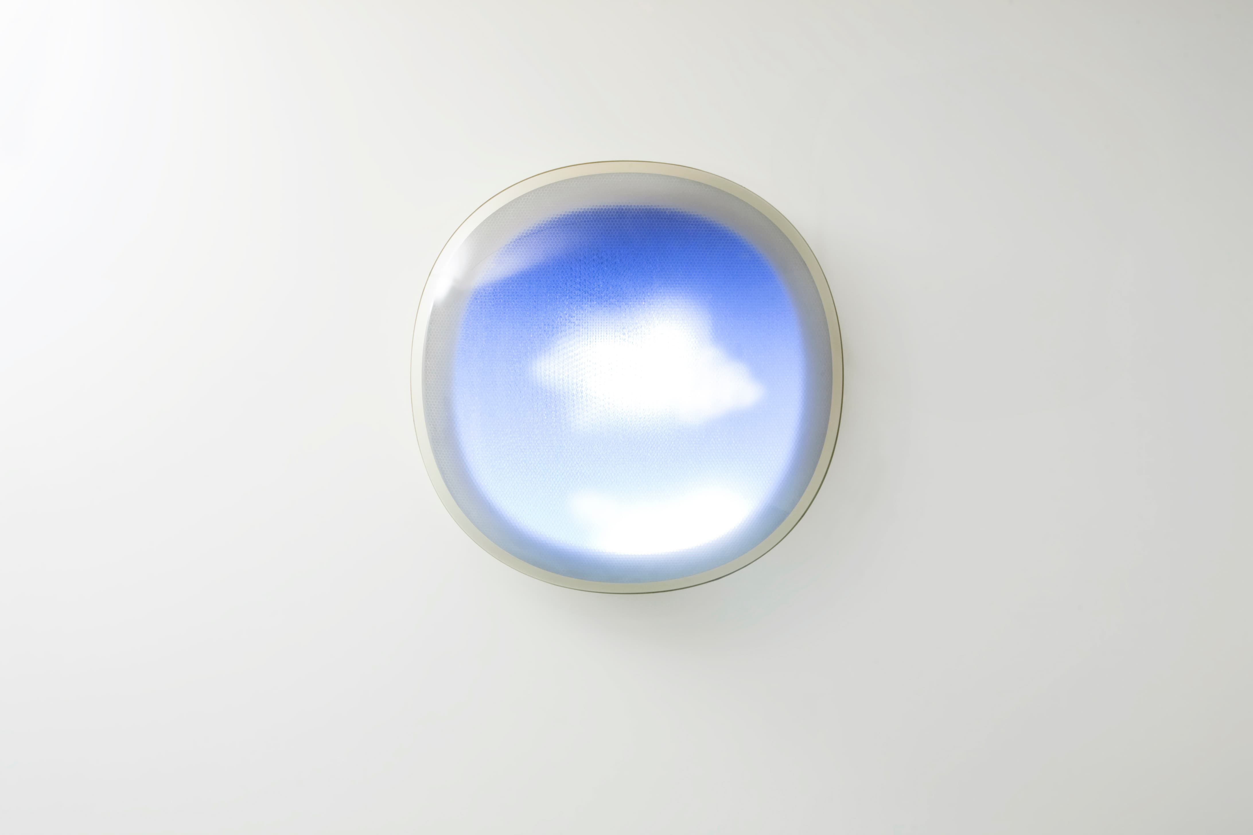 Image of Tomorrow is Another Day in the center, which looks like a circular airplane window looking out on a bright blue sky with a fluffy white cloud.